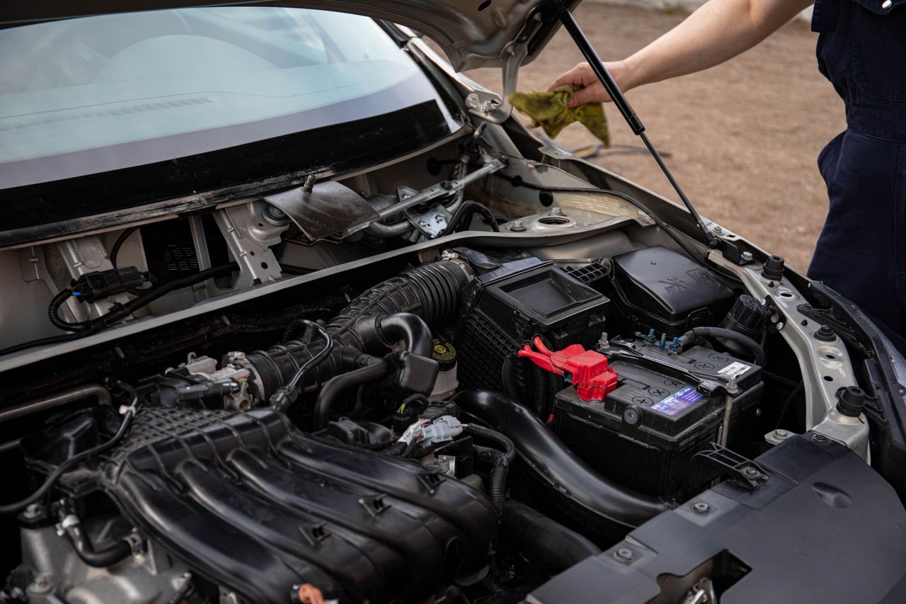 Open engine bay showing the intake tract, battery and engine harness a lambda sensor feeds into