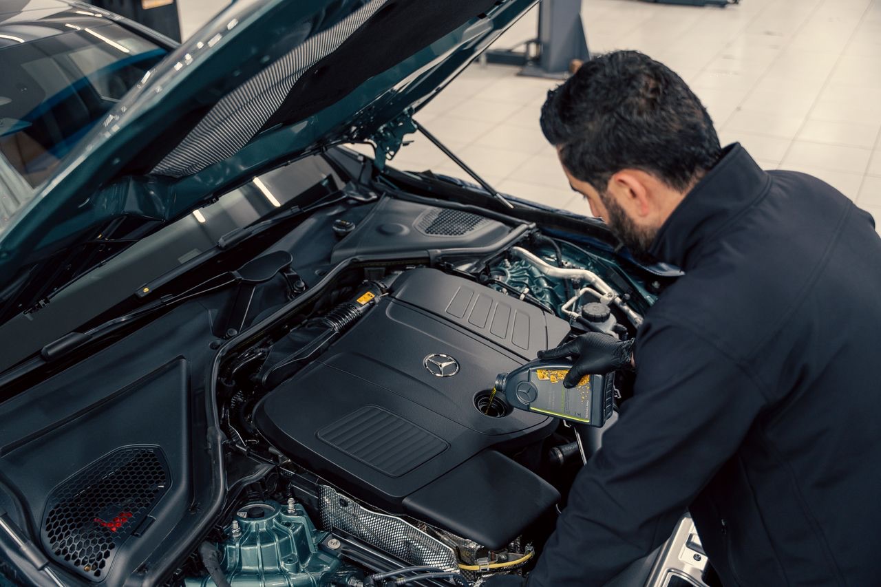 Technician working at an open engine bay