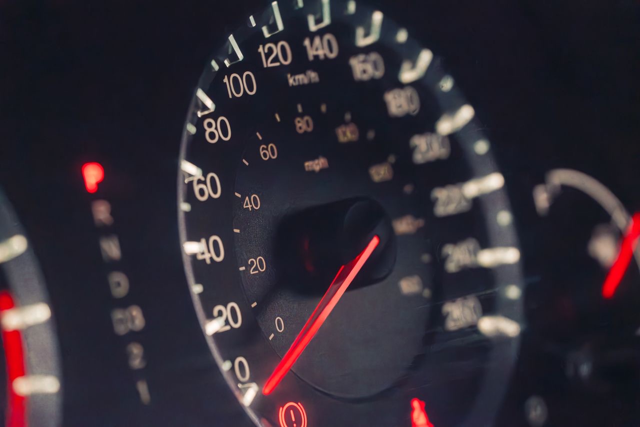 Instrument cluster at night with the tyre pressure warning lamp illuminated